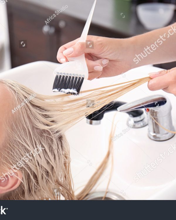 stock-photo-hairdresser-putting-mask-on-woman-s-hair-in-salon-536525845