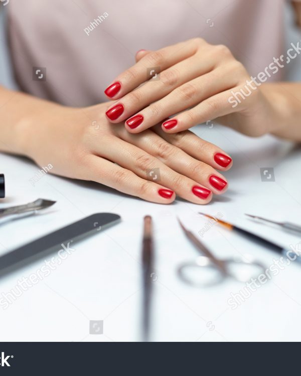 stock-photo-nail-care-closeup-of-beautiful-woman-hands-showing-perfect-nails-painted-with-red-nail-polish-on-550897681