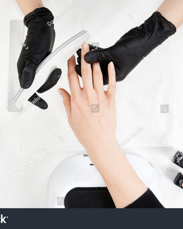 stock-photo-nail-tech-filing-nails-with-nail-file-professional-manicure-tools-629102171