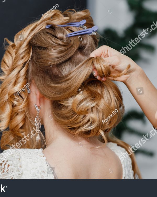stock-photo-young-bride-getting-her-hair-done-before-wedding-by-professional-hair-stylist-548920966